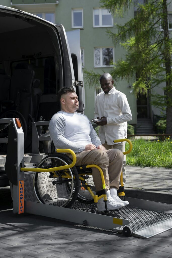Passenger in a wheelchair on the lift of an accessible van
